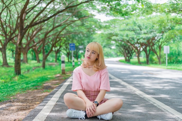 Portrait of beautiful asian girl golden hair with cameraThailand people in pink dresshipster girl