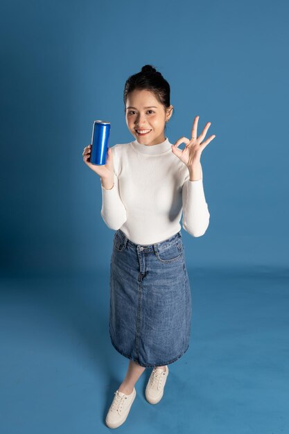 Portrait of beautiful asian girl posing on blue background