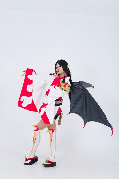 Portrait of beautiful asian girl wear cosplay game animation on white backgroundThailand peopleRed cloths devil style