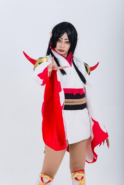 Portrait of beautiful asian girl wear cosplay game animation on white backgroundThailand peopleRed cloths devil style