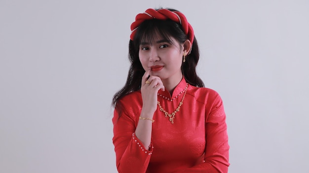 portrait of a beautiful Asian girl wearing a lot of gold jewelry smiling looking at the camera