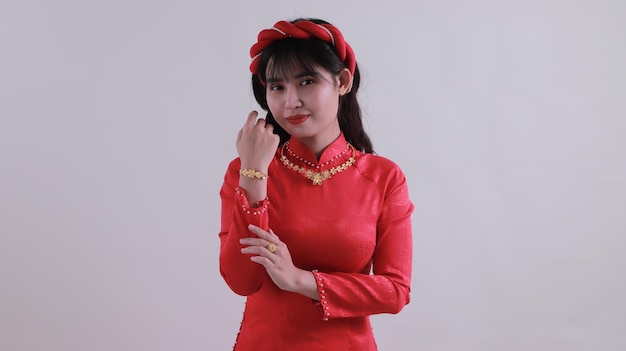 portrait of a beautiful Asian girl wearing a lot of gold jewelry smiling and looking at the camera