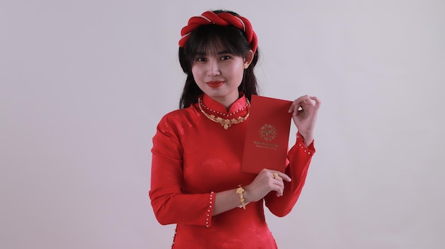 portrait of a beautiful Asian girl wearing a lot of gold jewelry smiling looking at the camera