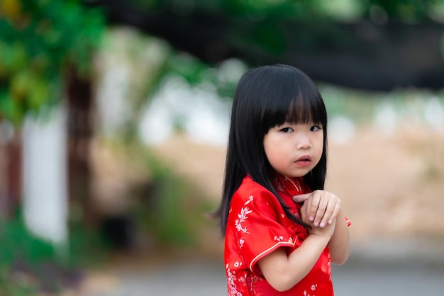 Portrait beautiful asian little girl in Cheongsam dressThailand peopleHappy Chinese new year conceptHappy Little asian girl in chinese traditional dress