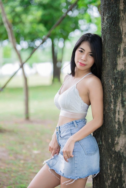 Portrait of beautiful asian woman black hair outdoorHappy woman conceptLifestyle of modern girlThailand people on the road in the forest