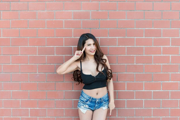 Portrait of beautiful asian woman on brick wall backgroundThailand people