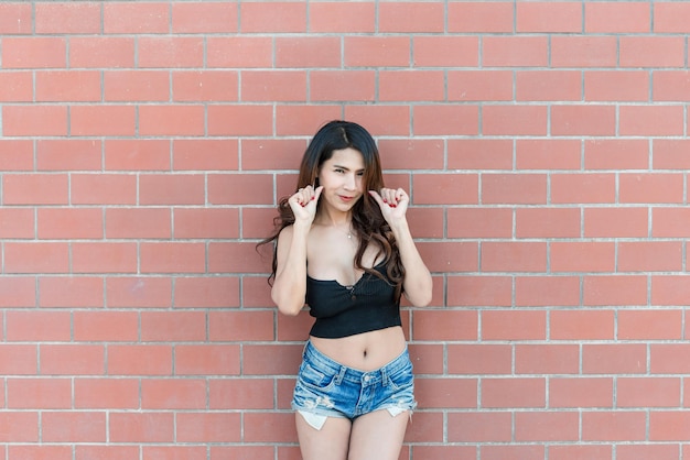 Portrait of beautiful asian woman on brick wall backgroundThailand people