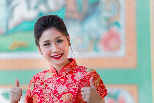 Portrait of beautiful asian woman in Cheongsam dressThailand peopleHappy Chinese new year concept