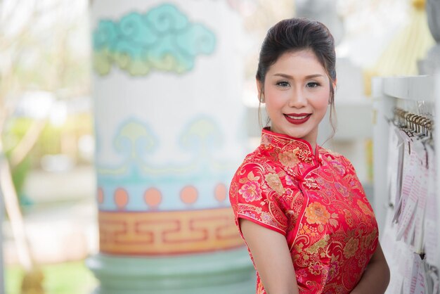 Portrait of beautiful asian woman in Cheongsam dressThailand peopleHappy Chinese new year concept