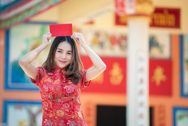 Portrait of beautiful asian woman in Cheongsam dressThailand peopleHappy Chinese new year concept