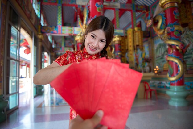 Portrait of beautiful asian woman in Cheongsam dressThailand peopleHappy Chinese new year concept