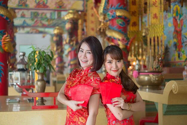 Portrait of beautiful asian woman in Cheongsam dressThailand peopleHappy Chinese new year concept