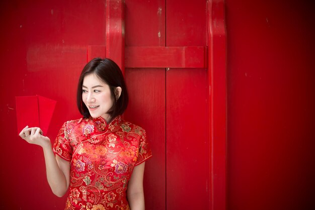 Portrait of beautiful asian woman in Cheongsam dressThailand peopleHappy Chinese new year concept