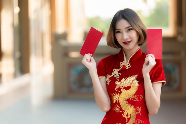 Portrait beautiful asian woman in Cheongsam dressThailand peopleHappy Chinese new year conceptHappy asian lady in chinese traditional dress