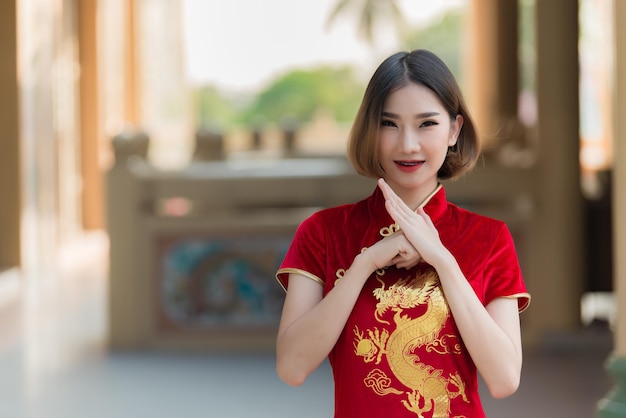 Portrait beautiful asian woman in Cheongsam dressThailand peopleHappy Chinese new year conceptHappy asian lady in chinese traditional dress