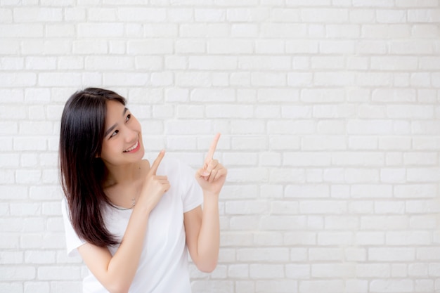 Portrait of beautiful asian woman happiness standing finger pointing