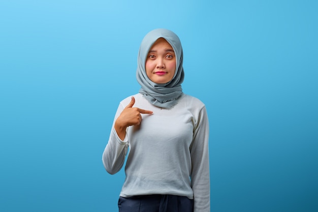 Portrait of beautiful Asian woman looking anxious and pointing herself