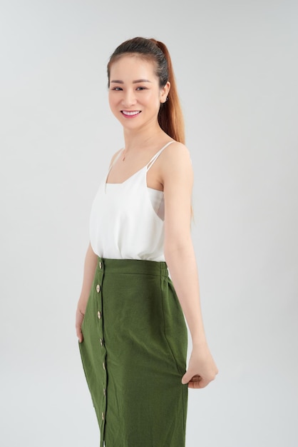 A portrait of a beautiful asian woman smiling brightly at the camera Isolated over white background