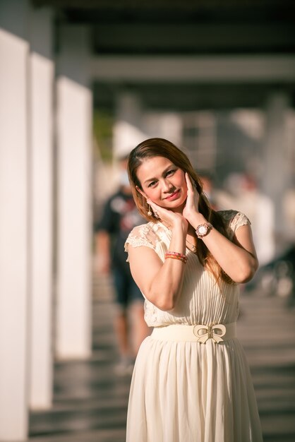 A portrait of a beautiful asian woman smiling brightly at the camera