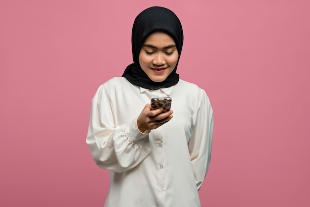 Portrait of beautiful Asian woman smiling and holding smartphone