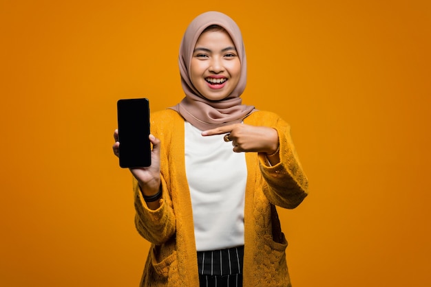 Portrait of beautiful asian woman smiling and pointing to smartphone
