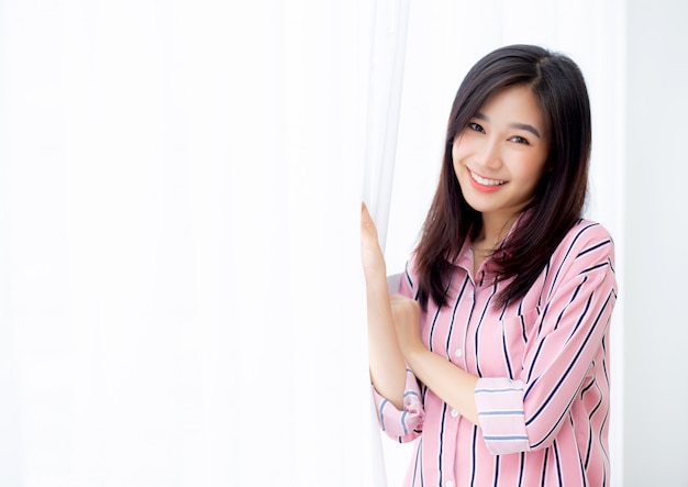 Portrait beautiful asian woman standing the window