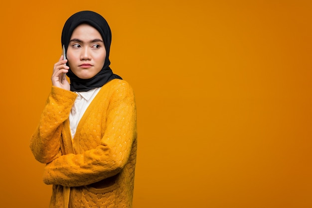 Portrait of beautiful Asian woman talking with a friend on mobile phone