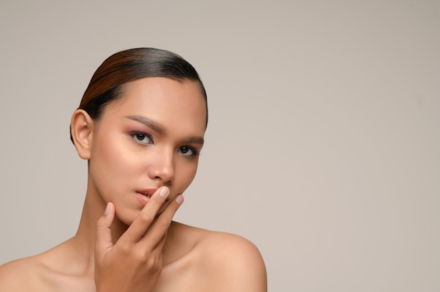 Portrait of beautiful asian woman touches on mouth