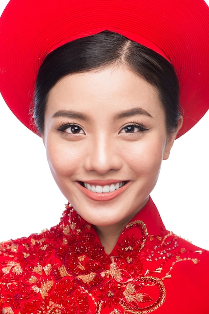 Portrait of a beautiful Asian woman on traditional festival costume Ao Dai. Tet holiday. Lunar New Year.