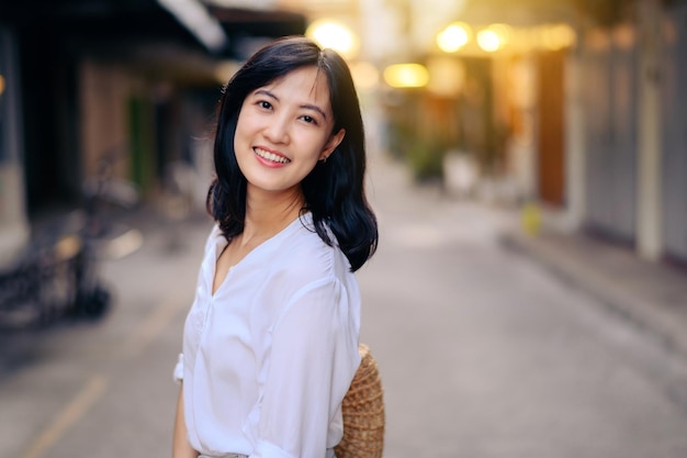 Portrait beautiful asian woman traveler smiling while explore street on summer vacation in Bangkok Thailand