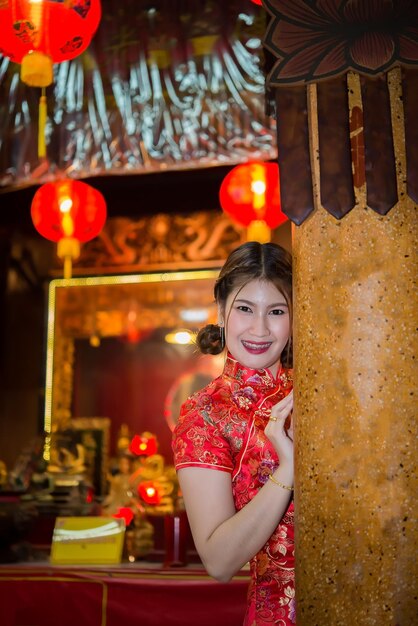 Portrait of beautiful asian woman wear cheongsam on light of lantern backgroundHappy chinese new yearThailand people