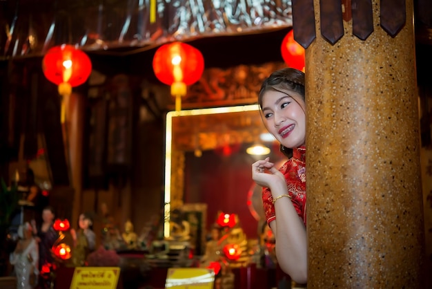 Portrait of beautiful asian woman wear cheongsam on light of lantern backgroundHappy chinese new yearThailand people