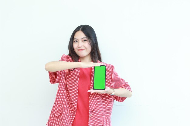 portrait of beautiful asian woman wearing red outfit holding mobile phone and smiling