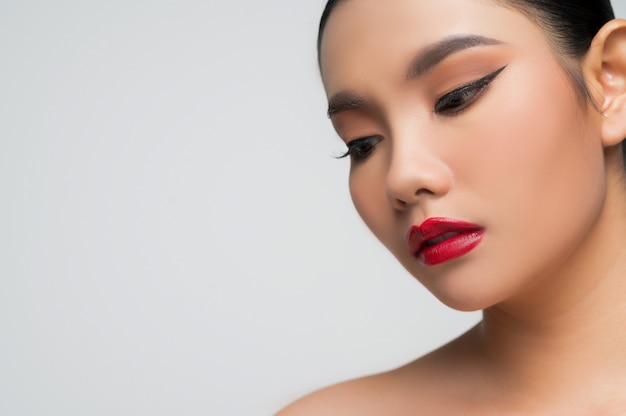 Portrait of beautiful asian woman with black hair and red lips