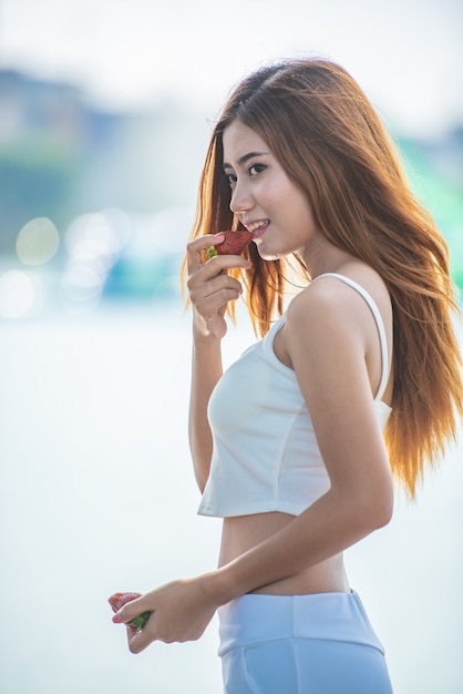 Portrait of a beautiful Asian woman with strawberry.