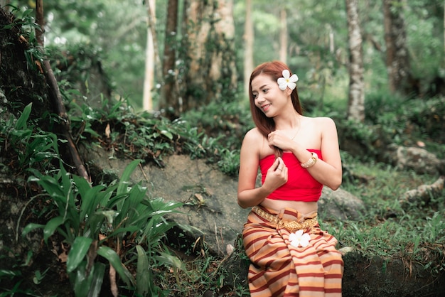 Portrait of beautiful asian women at waterfall in the jungle