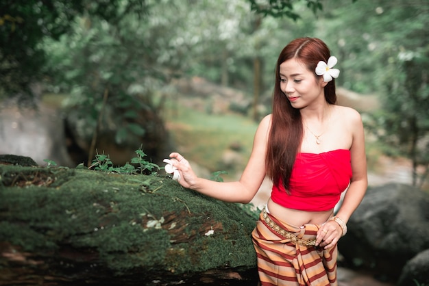 Portrait of beautiful asian women at waterfall in the jungle