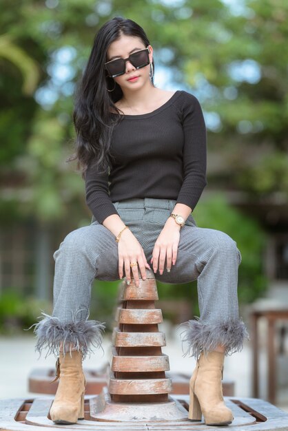 Portrait of beautiful asian young woman or thai young women in a luxury suite,woman is happily at the park on a relaxing holiday