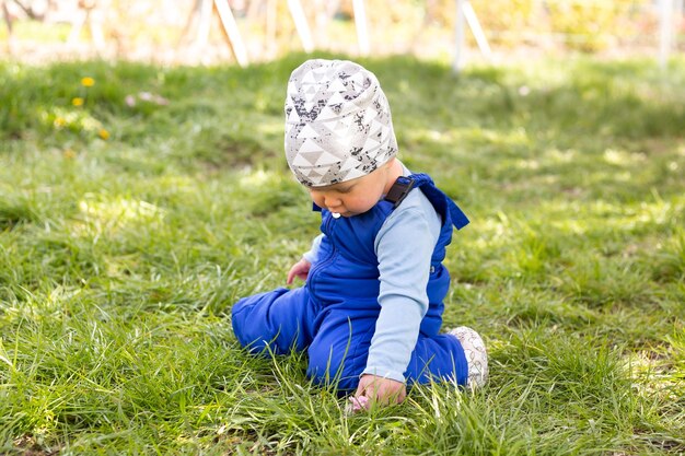 Portrait of beautiful baby boy on a grass