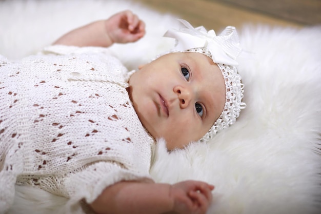 Portrait of a beautiful baby girl in a white dress close-up