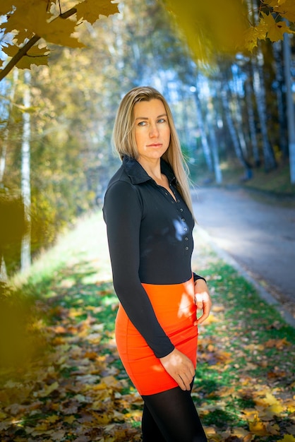 Portrait of a beautiful blonde in an autumn park