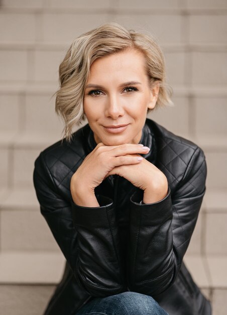 Portrait of a beautiful blonde woman in a black leather jacket