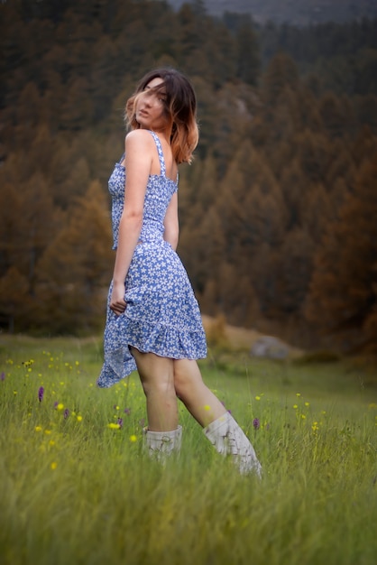 Portrait of a beautiful blonde woman on the mountains