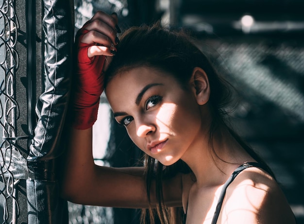 Portrait of beautiful boxer by window at gym