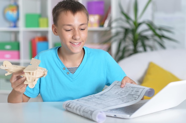 Portrait of beautiful boy using modern laptop at home