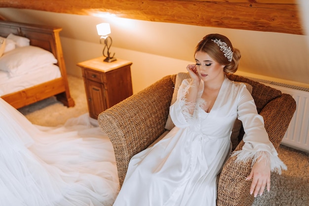 Portrait of a beautiful bride in a hotel near a wedding dress preparation for the wedding ceremony horizontal photo