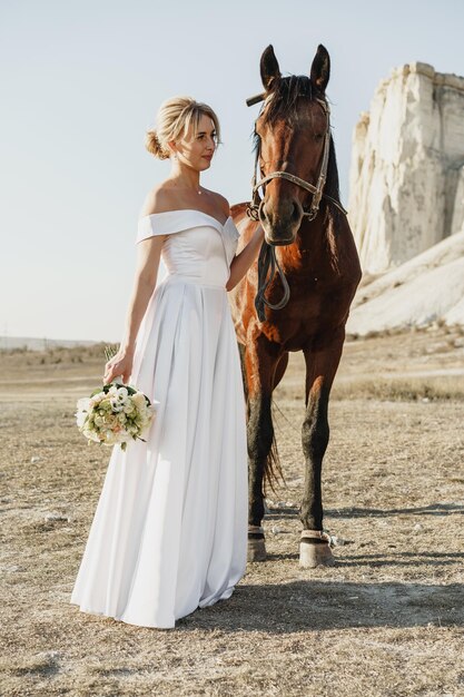 Portrait of a beautiful bride with horse