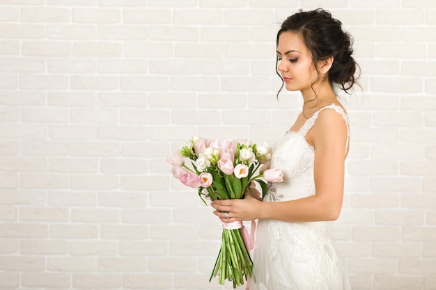 Ritratto di bella sposa con bouquet da sposa