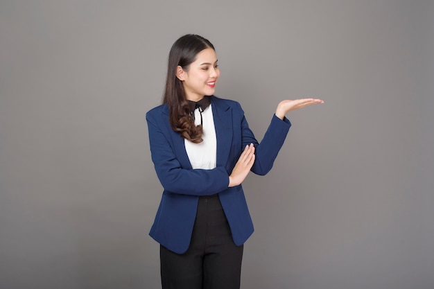 Portrait of beautiful brunette business  woman on gray background studio