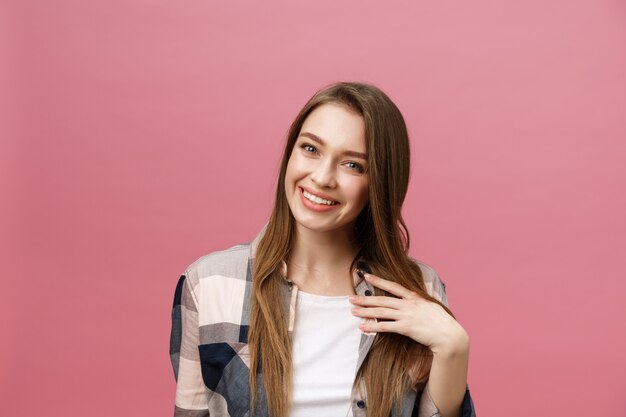 Portrait of beautiful brunette caucasian woman in pink studio